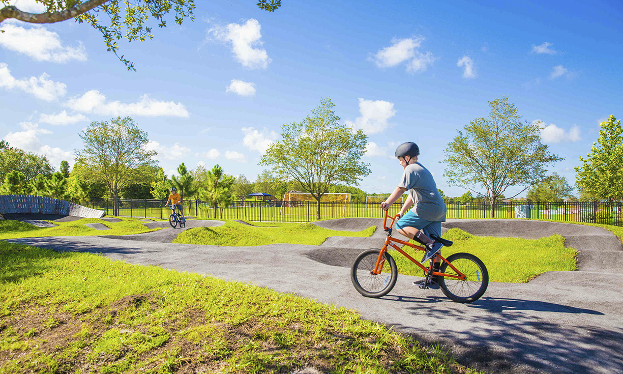 ©EDSA | Bexley Ranch | Child Riding Bike in Park